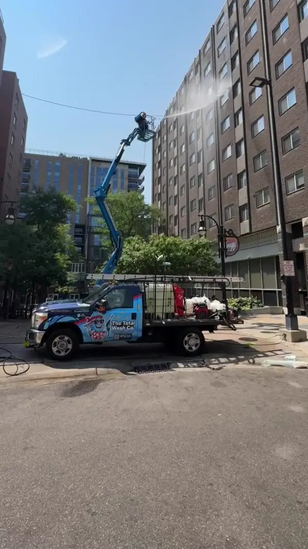 The Total Wash Co. lift truck cleaning building exterior in Madison